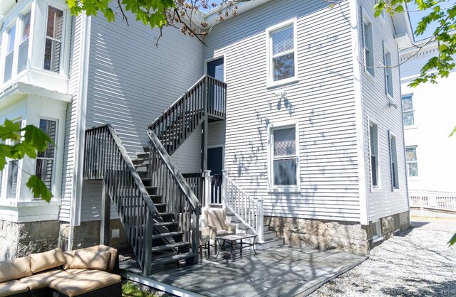 rear view of property with stairs