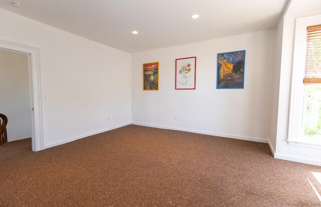 spare room with carpet floors, recessed lighting, and baseboards