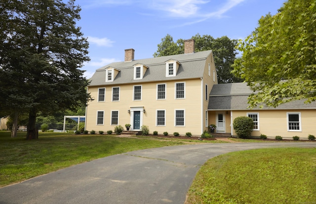 134 School House Rd, Old Saybrook, CT 06475 - colonial home featuring a chimney, a front yard, and a shingled roof
