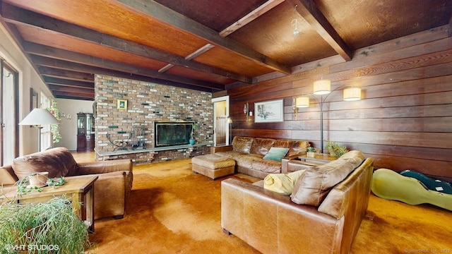 carpeted living room featuring beamed ceiling, wood walls, a fireplace, and wood ceiling