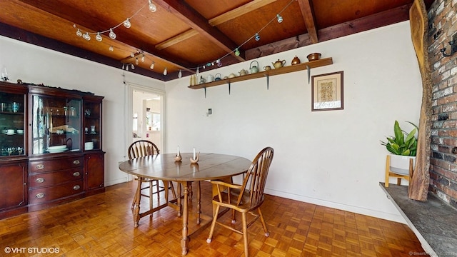 dining space with wood ceiling, beam ceiling, and baseboards