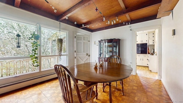dining area featuring rail lighting, a baseboard radiator, baseboards, beam ceiling, and wooden ceiling