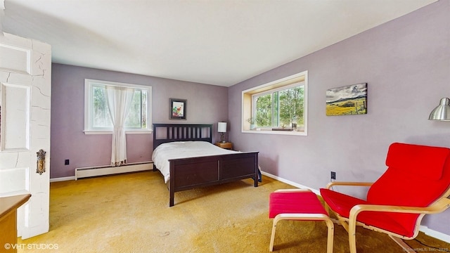 bedroom with a baseboard radiator, multiple windows, baseboards, and carpet