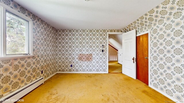 unfurnished room featuring a baseboard radiator, light colored carpet, wallpapered walls, and baseboards