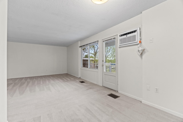 281 Gardner Ave Unit G5, New London, CT 06320 - carpeted spare room featuring a wall unit AC, a textured ceiling, and baseboards