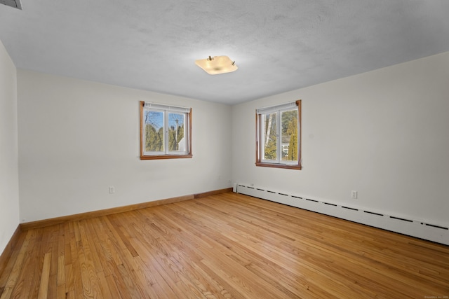42A New London Rd, Groton, CT 06355 - unfurnished room featuring a baseboard radiator, light wood finished floors, and baseboards