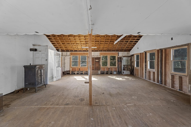 42A New London Rd, Groton, CT 06355 - unfurnished living room with a wood stove and vaulted ceiling