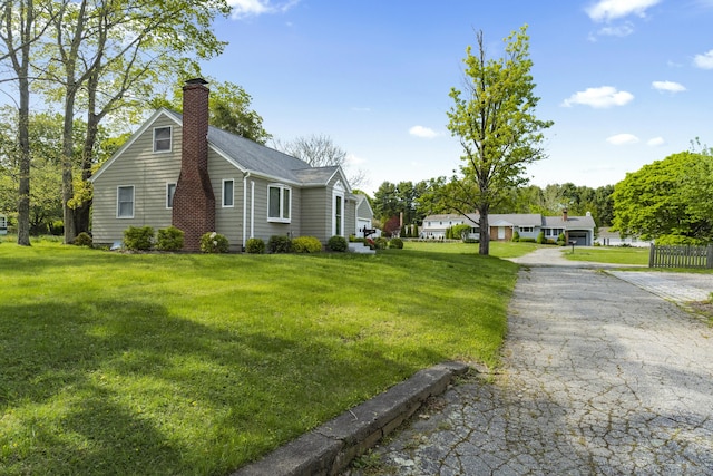 42A New London Rd, Groton, CT 06355 - view of property exterior with a chimney, a lawn, and roof with shingles