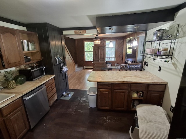 bathroom featuring wood walls, ceiling fan, and a baseboard radiator