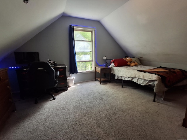 bedroom featuring lofted ceiling, a desk, and carpet flooring