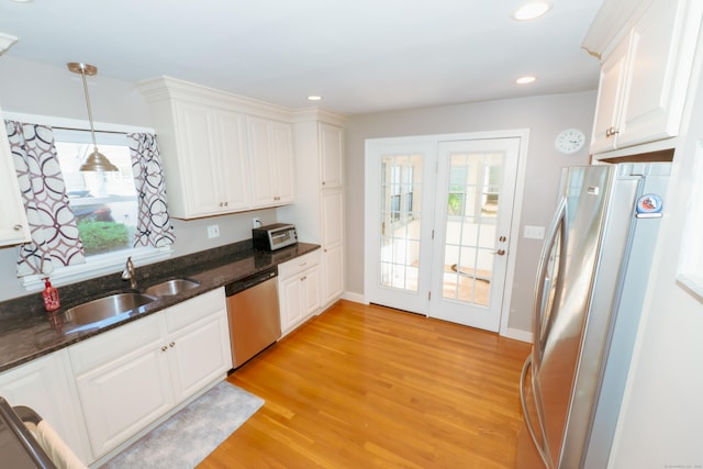 169 Laughlin Rd E, Stratford, CT 06614 - kitchen featuring stainless steel appliances, a sink, light wood-type flooring, white cabinetry, and recessed lighting
