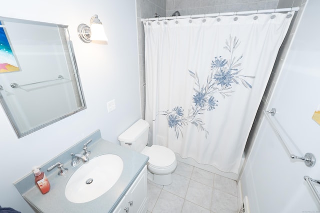 full bathroom featuring toilet, vanity, and tile patterned floors