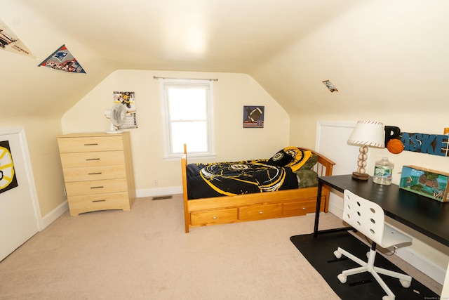 bedroom featuring lofted ceiling, light carpet, and baseboards