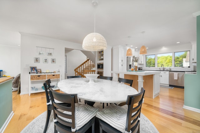 dining room featuring stairway, light wood finished floors, recessed lighting, crown molding, and baseboards
