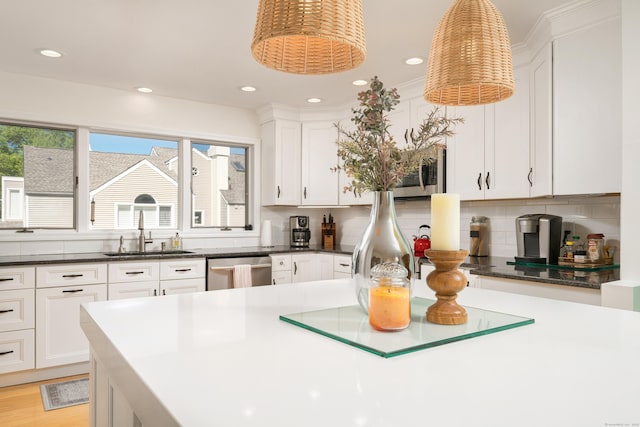 kitchen featuring a sink, appliances with stainless steel finishes, white cabinetry, decorative backsplash, and recessed lighting