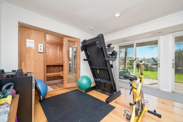 workout room with ornamental molding, wood finished floors, and recessed lighting