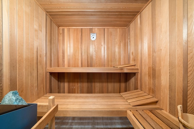 sauna with wooden walls and wood ceiling