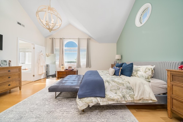 bedroom featuring wood finished floors, a chandelier, multiple windows, and lofted ceiling