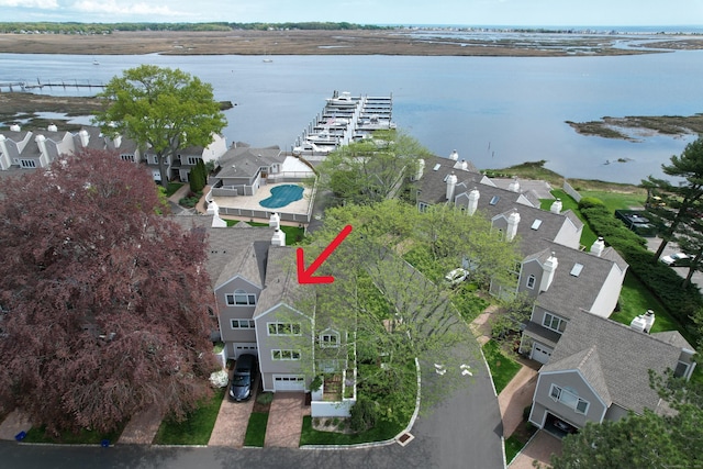 view of property location featuring a nearby body of water and nearby suburban area