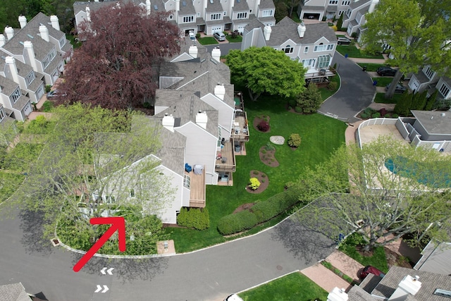 aerial view of property and surrounding area featuring nearby suburban area