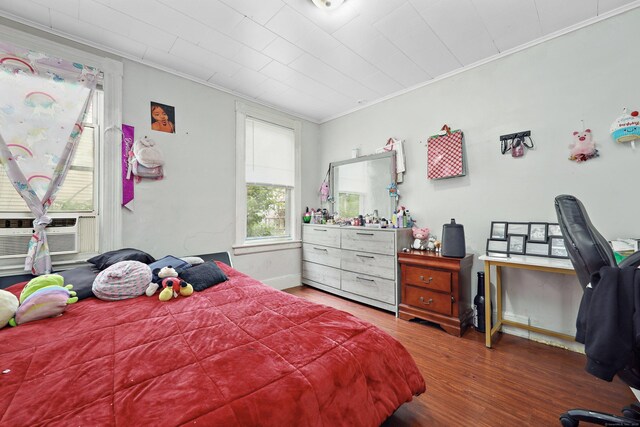 55 Lounsbury Ave, Waterbury, CT 06706 - bedroom featuring ornamental molding, wood finished floors, multiple windows, cooling unit, and baseboards