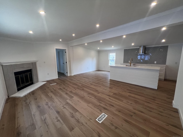 28 Crescent Park Rd, Westport, CT 06880 - unfurnished living room featuring a sink, ornamental molding, a glass covered fireplace, wood finished floors, and baseboards