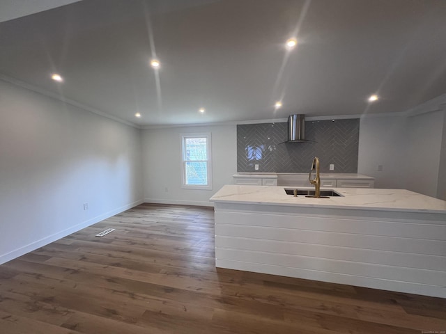 28 Crescent Park Rd, Westport, CT 06880 - kitchen with wall chimney exhaust hood, a sink, ornamental molding, white cabinetry, and a kitchen island with sink