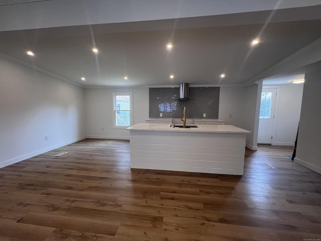 28 Crescent Park Rd, Westport, CT 06880 - kitchen featuring wall chimney range hood, a center island with sink, healthy amount of natural light, dark wood-style floors, and crown molding
