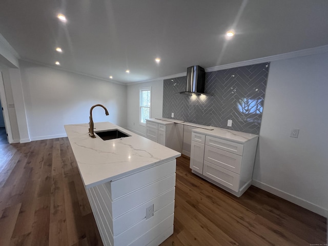 28 Crescent Park Rd, Westport, CT 06880 - kitchen featuring wall chimney range hood, a sink, ornamental molding, light stone countertops, and a kitchen island with sink