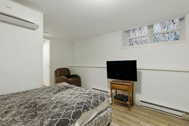 9 Brewer St Unit 1, New London, CT 06320 - bedroom with a wall mounted AC, a baseboard radiator, and wood finished floors