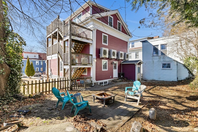 9 Brewer St Unit 1, New London, CT 06320 - rear view of house featuring an outdoor fire pit, fence, ac unit, and a balcony