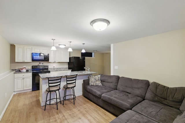9 Brewer St Unit 1, New London, CT 06320 - living area featuring light wood-style flooring and baseboards