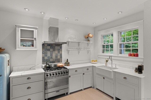 21 Rte 7, Salisbury, CT 06796 - kitchen with gas stove, a sink, wall chimney range hood, open shelves, and light stone countertops
