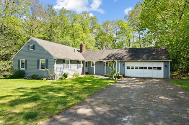 view of front of property with driveway, a chimney, a garage, board and batten siding, and a front lawn