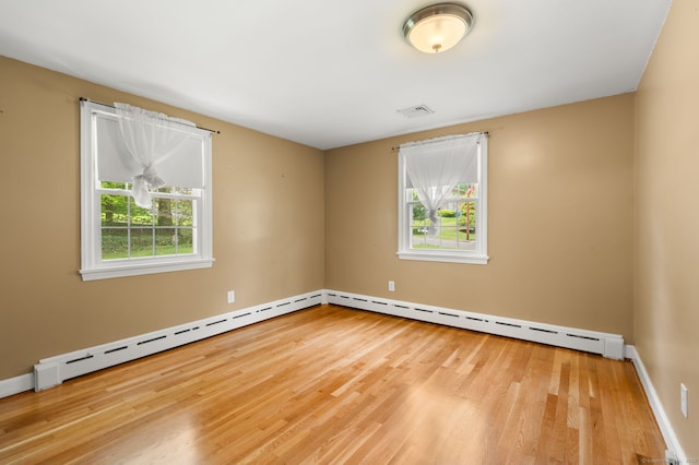 empty room featuring wood finished floors and baseboards