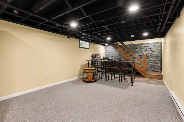 below grade area featuring a baseboard radiator, carpet flooring, stairway, and baseboards