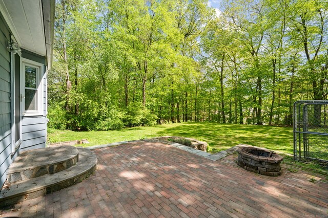 view of patio / terrace featuring an outdoor fire pit