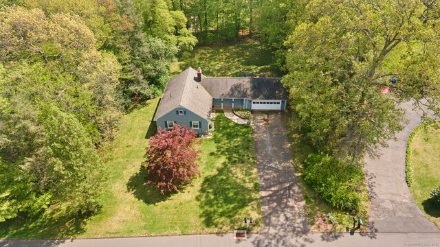 aerial view of property and surrounding area with a forest