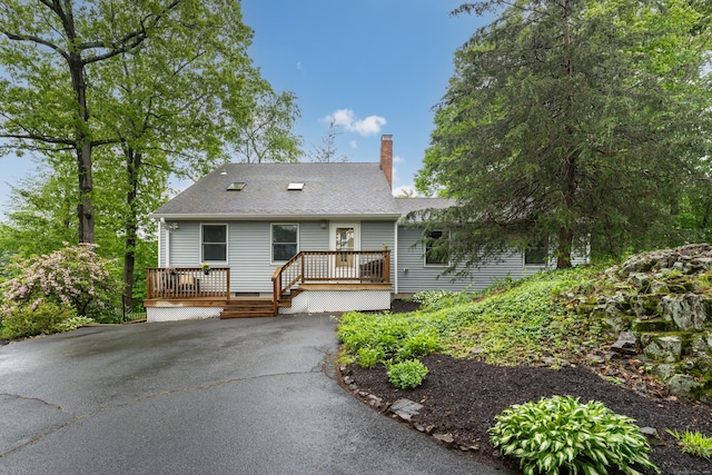 255 Back Ln, Newington, CT 06111 - view of front of property with a wooden deck, a chimney, and a shingled roof