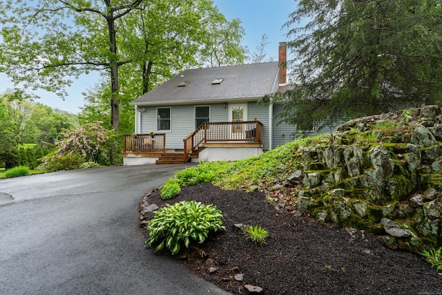 255 Back Ln, Newington, CT 06111 - view of front of property with a chimney, a wooden deck, and asphalt driveway
