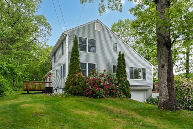 255 Back Ln, Newington, CT 06111 - view of side of home with central AC unit, an attached garage, a wooden deck, and a yard