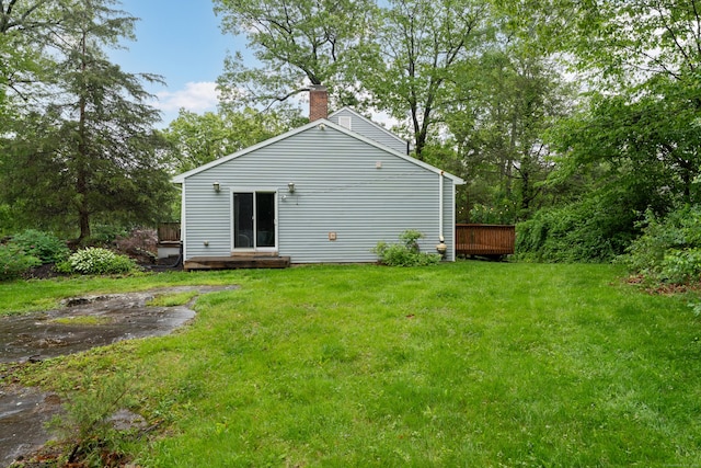 255 Back Ln, Newington, CT 06111 - back of house with a chimney, a yard, and a wooden deck