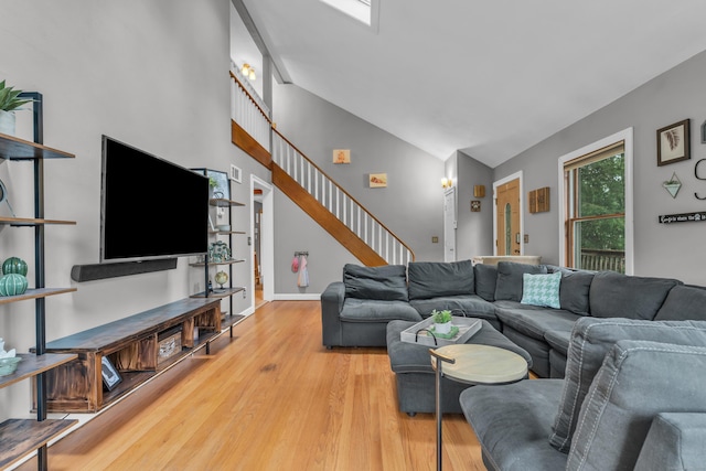 255 Back Ln, Newington, CT 06111 - living room featuring wood finished floors, high vaulted ceiling, stairs, and baseboards