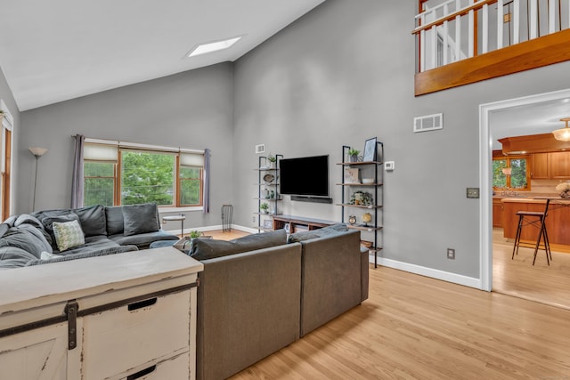 255 Back Ln, Newington, CT 06111 - living room with high vaulted ceiling, light wood-style flooring, plenty of natural light, and baseboards