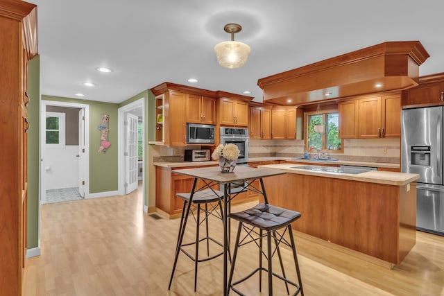 255 Back Ln, Newington, CT 06111 - kitchen with appliances with stainless steel finishes, light countertops, light wood-type flooring, backsplash, and recessed lighting