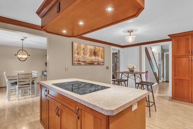 255 Back Ln, Newington, CT 06111 - kitchen with black electric stovetop, light wood-type flooring, a center island, light countertops, and recessed lighting