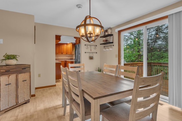 255 Back Ln, Newington, CT 06111 - dining space featuring a chandelier, light wood-type flooring, and baseboards