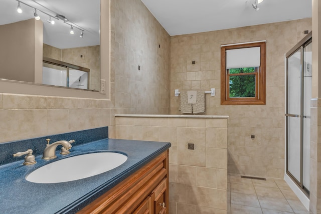 255 Back Ln, Newington, CT 06111 - full bathroom featuring a stall shower, tile walls, vanity, rail lighting, and tile patterned flooring