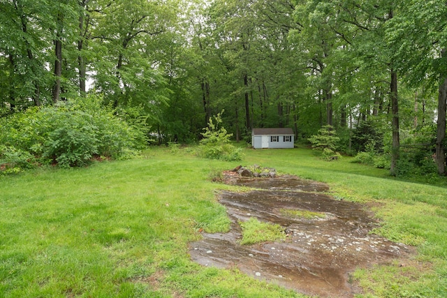 255 Back Ln, Newington, CT 06111 - view of green lawn with an outdoor structure and a wooded view