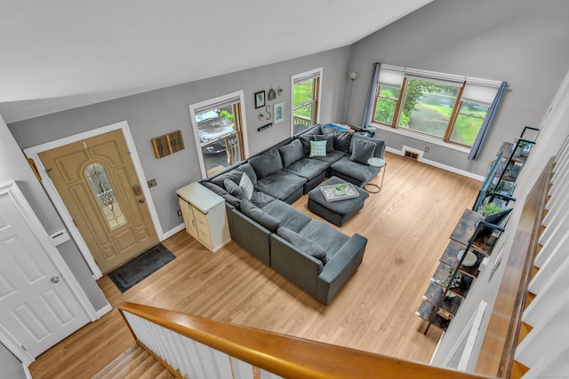 255 Back Ln, Newington, CT 06111 - living area featuring light wood-style floors, baseboards, lofted ceiling, and stairs